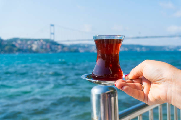 istock A hand holding a tea at istanbul bosphorus view 1174500424