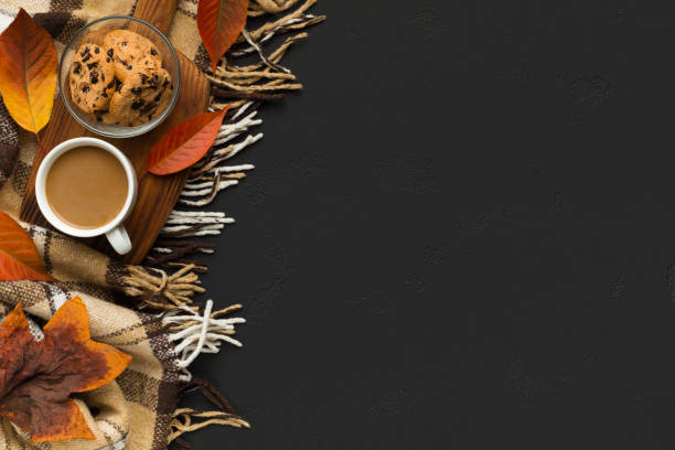 istock Coffee with biscuit on background with scarf and fallen leaves 1174500526
