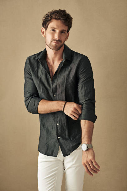 istock Handsome young man in daily casual outfit posing over studio background 1174500714
