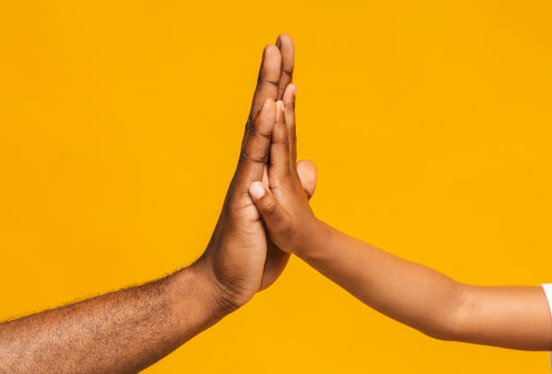 istock High five gesture of african father and child 1174500909