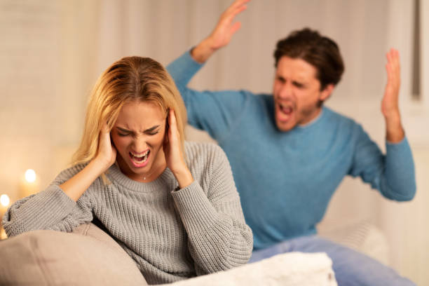 istock Aggressive Man Shouting At Woman Sitting On Sofa At Home 1174501917