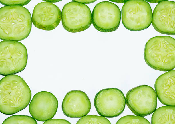 istock Fresh cucumber slices on white background. 1174501954
