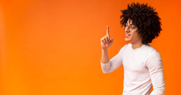 istock Profile portrait of black inspired guy pointing finger up 1174502409