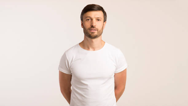 istock Man Standing With Hands Behind Back Looking At Camera, Isolated 1174502488