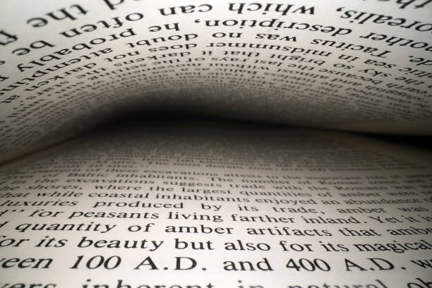 istock Inside the book concept. Latin letters and words on an open book with black dramatic background. Education, knowledge concept 1174503492