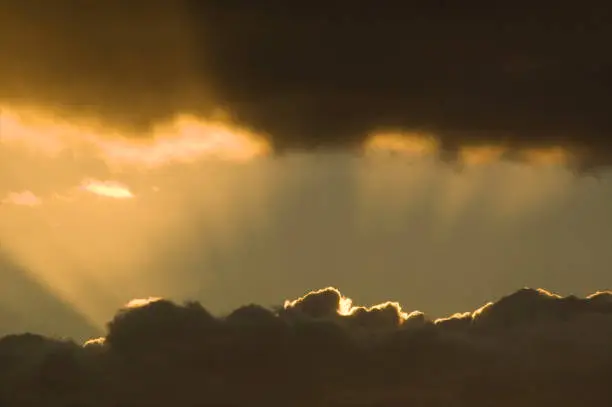 The sun bursts through the layers of clouds