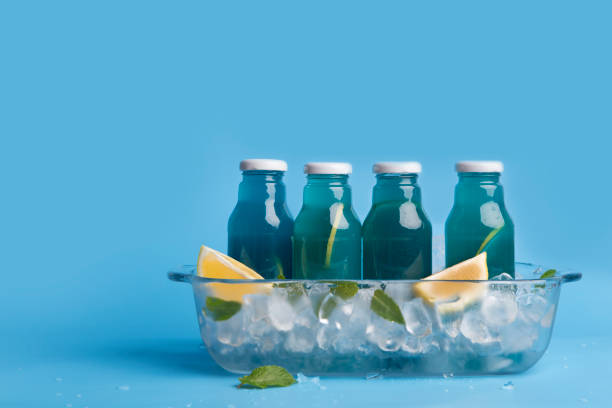 istock Summer refreshing drink in blue bottle with fresh lemon slices 1174505620