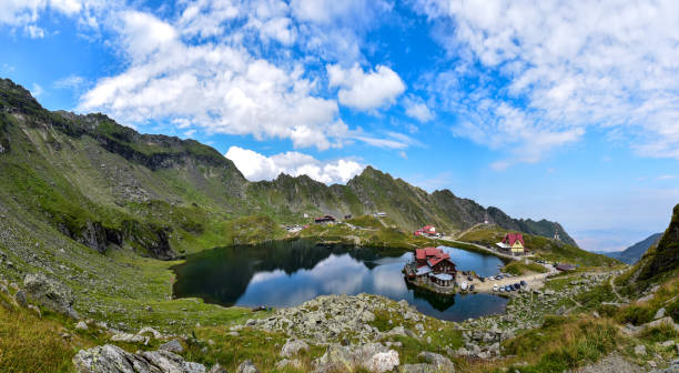 Landscape with Balea lake Balea lake and chalet in Fagaras mountains, Romania balea lake romania stock pictures, royalty-free photos & images