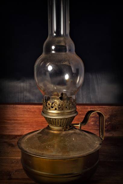 istock Old kerosene lamp on a wooden background 1174508358