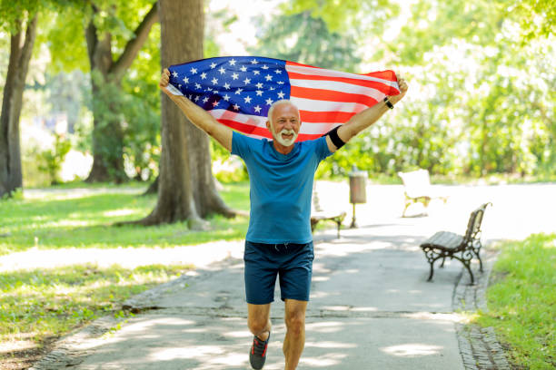 istock Senior Man with American Flag in Public Park 1174509276
