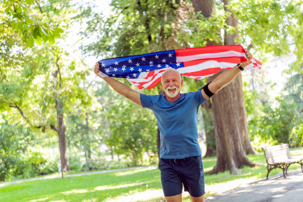 istock Senior Man with American Flag in Public Park 1174509349