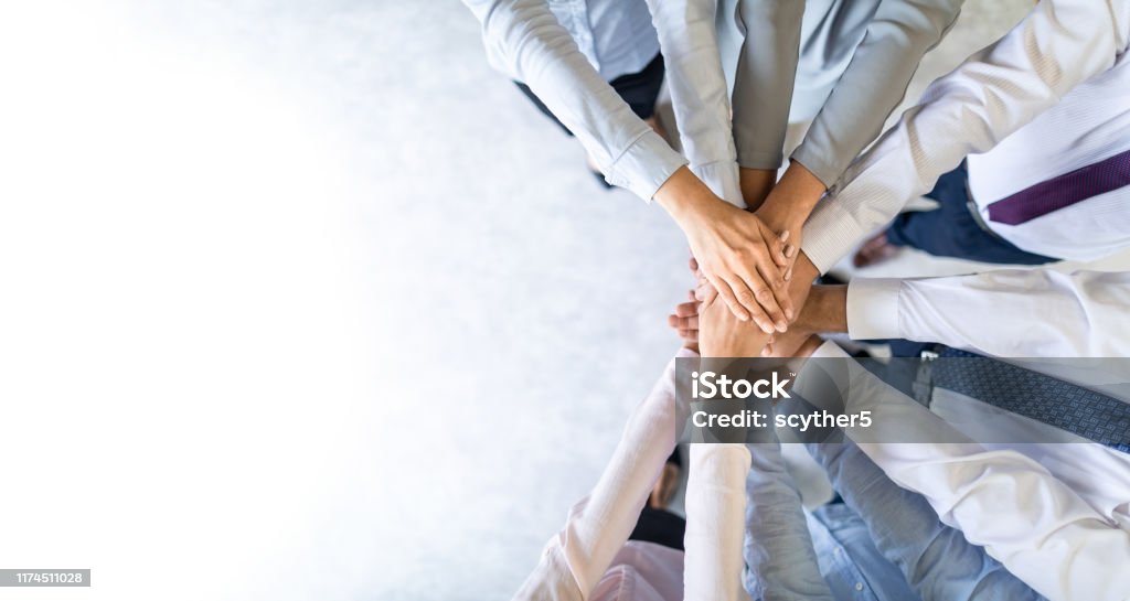 Stack of hands. Unity and teamwork concept. Close up top view of young business people putting their hands together. Stack of hands. Unity and teamwork concept. Teamwork Stock Photo