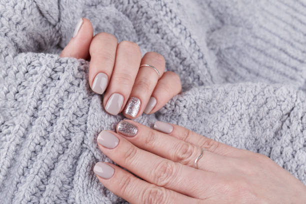 istock Manicured woman hands with pastel nail polish 1174511077