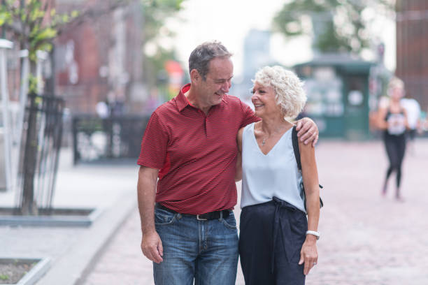 istock Senior couple walking through city 1174512101