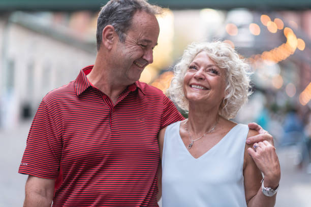 istock Senior couple walking through city 1174512109