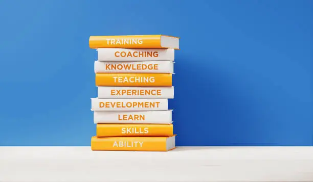 Photo of Books of  Training And Development in Front of Blue Wall