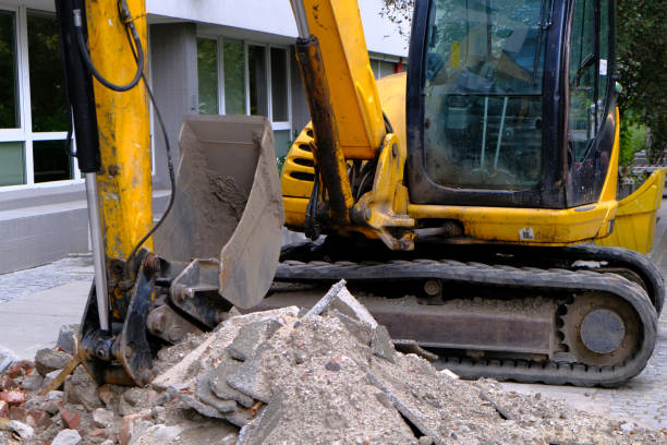 istock Yellow Small Excavator work on a Sidewalk in the city center. 1174513212