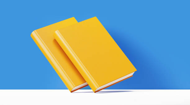 Yellow book pair in front of blue background. Horizontal composition with copy space.
