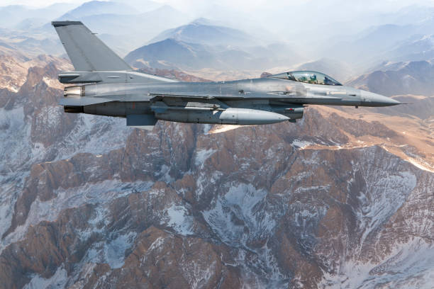 istock Figher jet flying over the mountains 1174518157