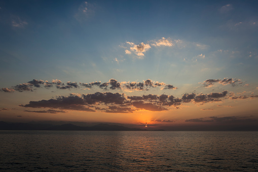 The sun goes down over a lake. Dramatic Sunset Sky