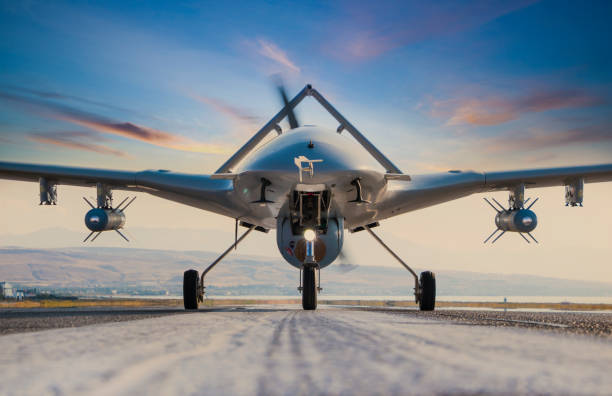 вооруженный беспилотный летательный аппарат на взлетно-посадочной полосе - military air vehicle стоковые фото и изображения
