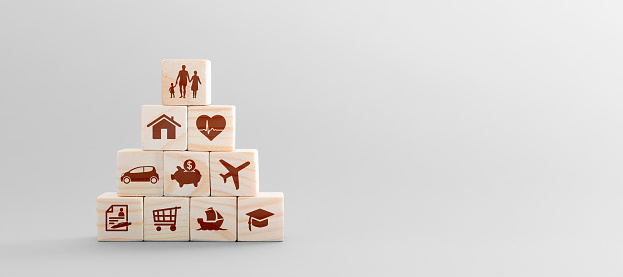 Wooden blocks with icons of various types of insurance. Life insurance concept.