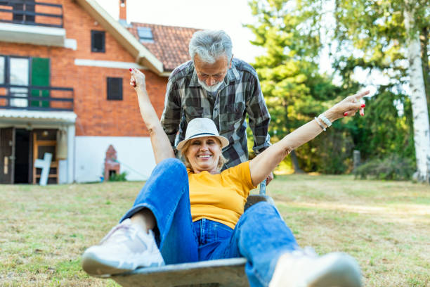 istock Happy senior couple playing with a wheelbarrow 1174518936