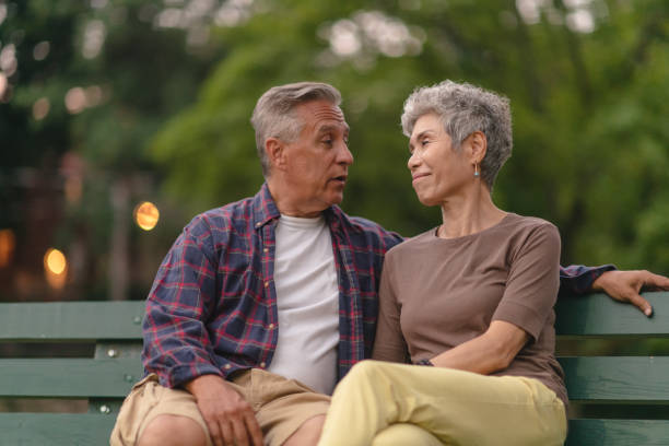 istock Senior couple sitting on park bench 1174519666