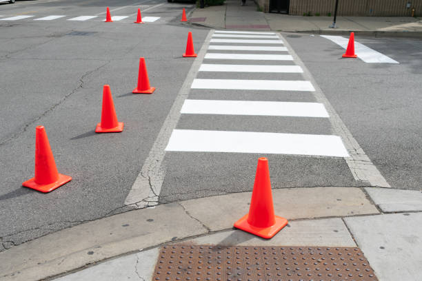 istock Orange Cones around a Freshly Painted Urban Crosswalk 1174522733
