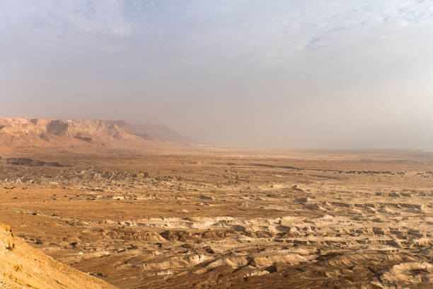 Top view from Masada fortress to the Judaean desert and the Dead Sea. The desert land of Israel. Background of canyon in the desert. Desert in which 40 years Moses was looking for the promised land. Top view from Masada fortress to the Judaean desert and the Dead Sea. The desert land of Israel. Background of canyon in the desert. Desert in which 40 years Moses was looking for the promised land west bank stock pictures, royalty-free photos & images