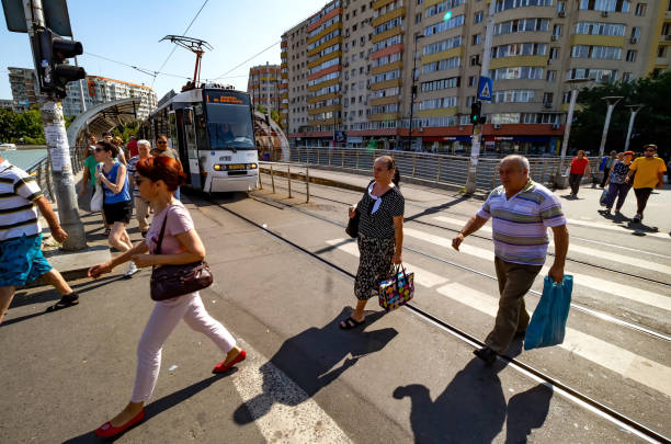 Bucharest, Romania - September 03, 2019: People cross the street with tram lines over Bucur-Obor Passage in Bucharest.
