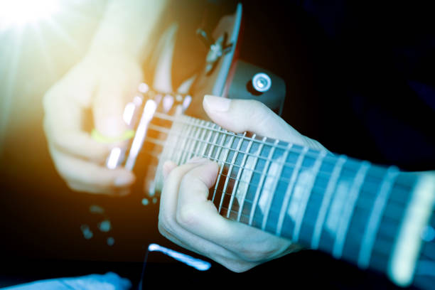istock The young man plays an electric guitar with fun 1174541096
