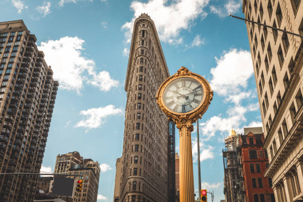 5TH Avenue Clock 5TH Avenue clock with the Flatiron Building in the background broadway manhattan stock pictures, royalty-free photos & images