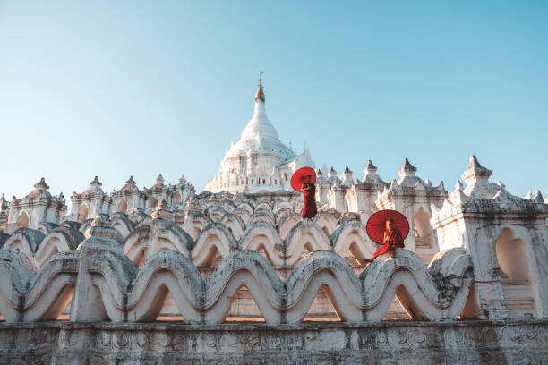 istock Novices under umbrellas at historic temple 1174541866