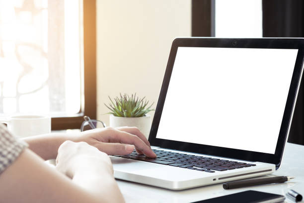 istock Man is typing on laptop computer keyboard which has white blank mock up screen. 1174542568