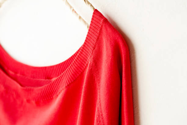 istock a cut sew or knit in red hanging on clothes hanger on white background. 1174544691