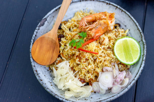 istock Thai food  fried rice whit shrimp in wood dish 1174548408