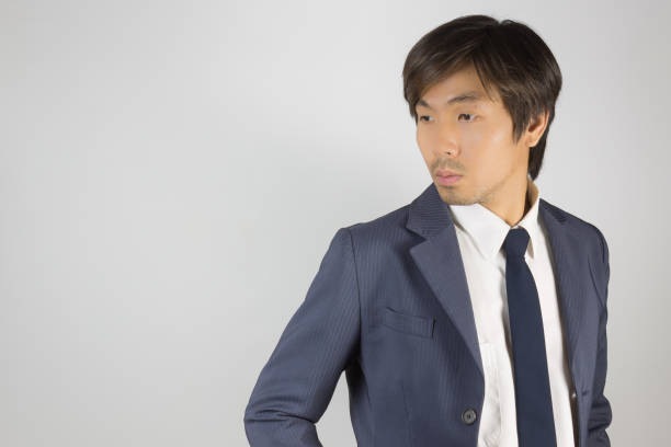 istock Young Asian Portrait Businessman in Navy Blue Suit Turn Back Pose at Right Frame 1174551029