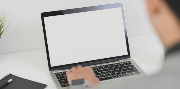 istock Young professional businessman working on his current project while typing on blank screen laptop 1174551146