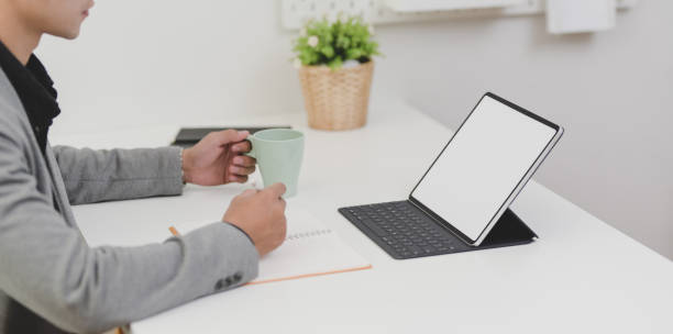 istock Young professional businessman working on his upcoming project while holding a cup of coffee 1174551735