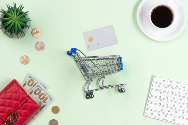 istock Online shopping concept. Computer keyboard, shopping cart and coffee with copy space. 1174558828