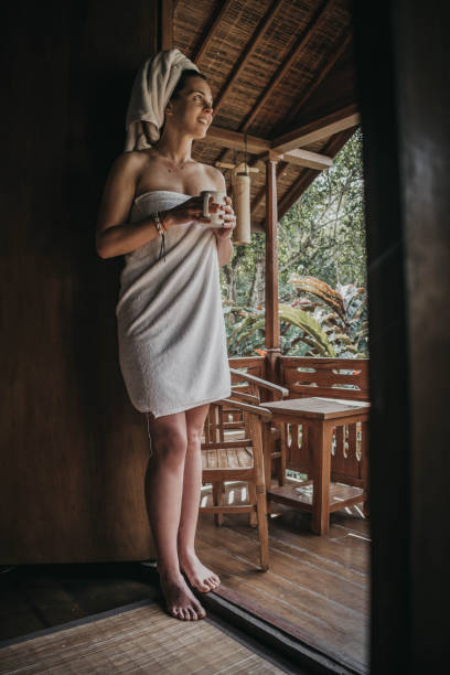 istock Woman drinking coffee on balcony with view on rice fields 1174559594