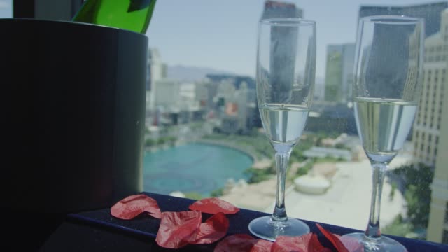 Champagne bottle and glasses in front of Las Vegas view