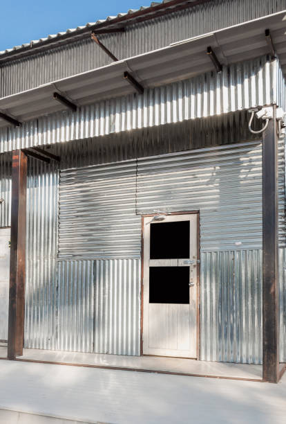 istock Corrugated galvanized steel surface silver of temporary shelter for construction workers and Industrial factory building. Iron metal sheet vintage style texture for background. 1174562199