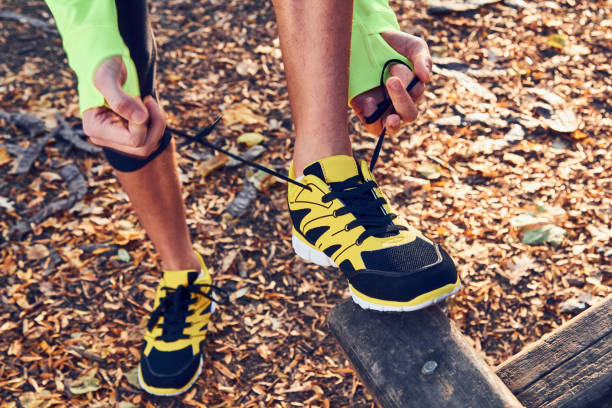 istock Preparing for jogging in autumn colored park. 1174565558