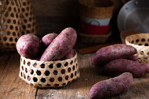 istock Sweet Potatoes Purple Colored on Table 1174565777