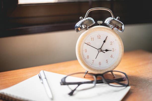 istock close up of glasses, clock and notebook on office table 1174568110