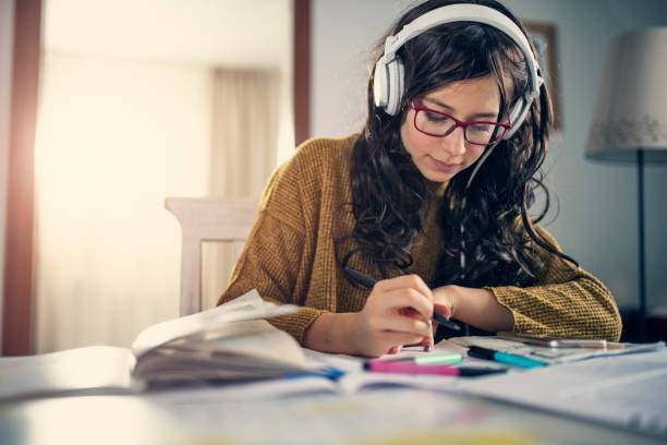 istock Teenage girl doing homework 1174569065