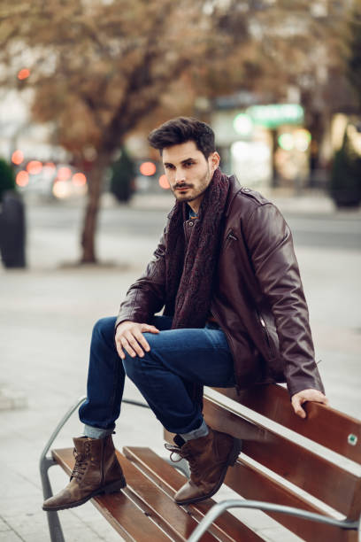 istock Thoughtful young man sitting on an urban bench. 1174571112