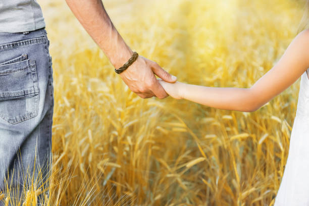 istock Child and father in a wheat field. Selective focus. 1174572453